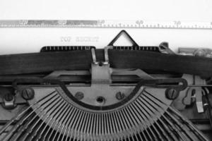 Old retro vintage typewriter. A white sheet with the printed text top secret.In black and white image.