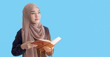 Portrait of a muslim woman on a blue background. copy space photo