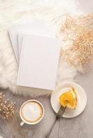 blank calendar mockup with carrot cake dessert, coffee and flowers on white rug photo