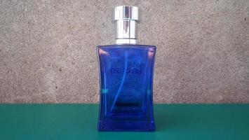 front view of purple perfume bottle photo