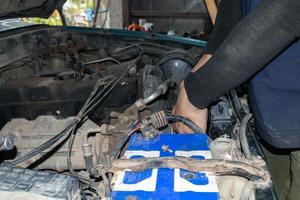 The mechanic is checking the engine. photo