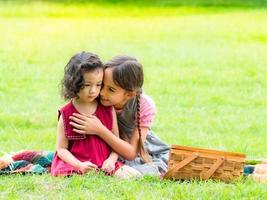 Groups of young children of many nationalities playing and older children console the younger children photo