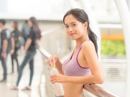 Asian cute woman relaxing after yoga in outdoor park photo