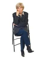 Serious senior business woman on chair photo