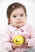 Silky baby holding an apple photo