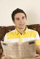 Smiling man read newspaper photo