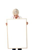 Senior woman holding  blank poster photo