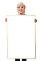 Senior businesswoman holding placard photo