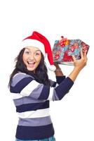 Amazed woman lifting Christmas gift photo