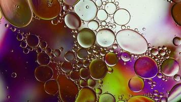 Abstract Colorful Food Oil Drops Bubbles and spheres Flowing on Water Surface, macro Videography video