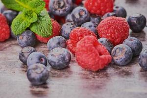 macro photo of blueberries beside raspberries