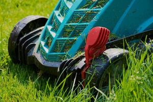 lawn mower close up while mowing photo