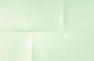 Light green crumpled unfolded paper sheet texture background. Paper folded in six. Full frame photo