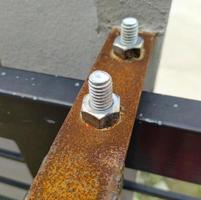 Focus on a pair of bolt-screws. Rusted iron. photo