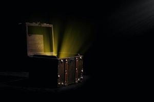 Soft gold shines in an old wooden chest with realistic composition on transparent background with vintage coffer and sparkling particles. photo