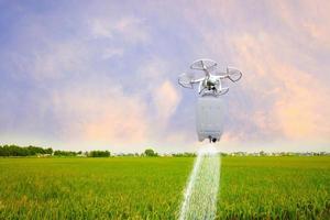 Smart farming is a drone flying to spray insecticide on the rice field. Smart farmers use a drone for various fields like research analysis, terrain scanning technology, and smart technology. photo