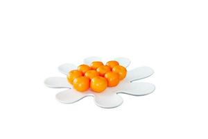 Orange fruit in white plate on white background.