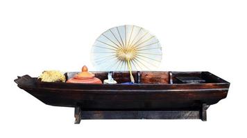 Antique white umbrellas placed on Old Wooden boat with Isolate Background. photo