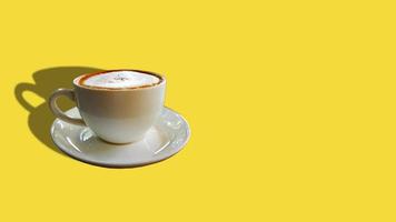 Cappuccino coffee and Space on Yellow background. photo