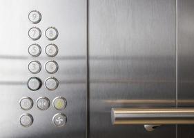 Railing and floor buttons in elevator of odern office photo