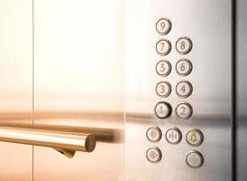 Elevator buttons with railing for holding photo