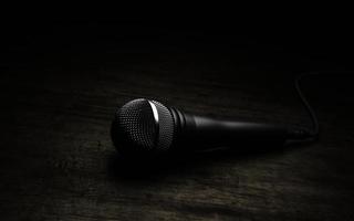 Microphone on wood background. 3d render
