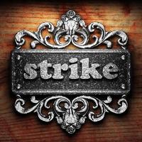 strike word of iron on wooden background photo