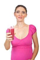 Pregnant woman holding strawberry juice photo