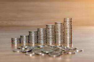 rows of coin stacks on wooden floor. banking concept. metaphor of international financial consulting photo