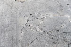 top view of cracks on concrete road photo