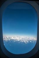 Blue sky outside the window of the air plane fly over Sydney, Australia. photo