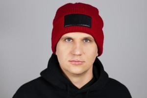 hipster in red winter hat isolated on grey background, blank,empty photo