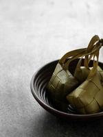 High angle view  of Ketupat in a bamboo bowl on the table photo