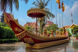 Beautiful boat with the monk statue on the boat in the temple photo