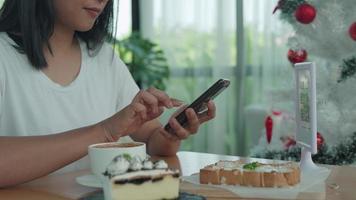 as mãos das mulheres estão usando o telefone para digitalizar o código qr para selecionar o menu de comida. digitalize para obter descontos ou pagar por comida. o conceito de usar um telefone para transferir dinheiro ou pagar dinheiro online sem dinheiro. video