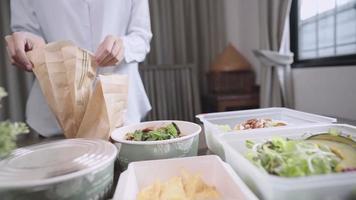 Working woman take out delivery food, setting up on dinning table, food Delivery service application, Vegetables Salad, toast healthy nutrition food, stay at home new normal adaptation lockdown covid video