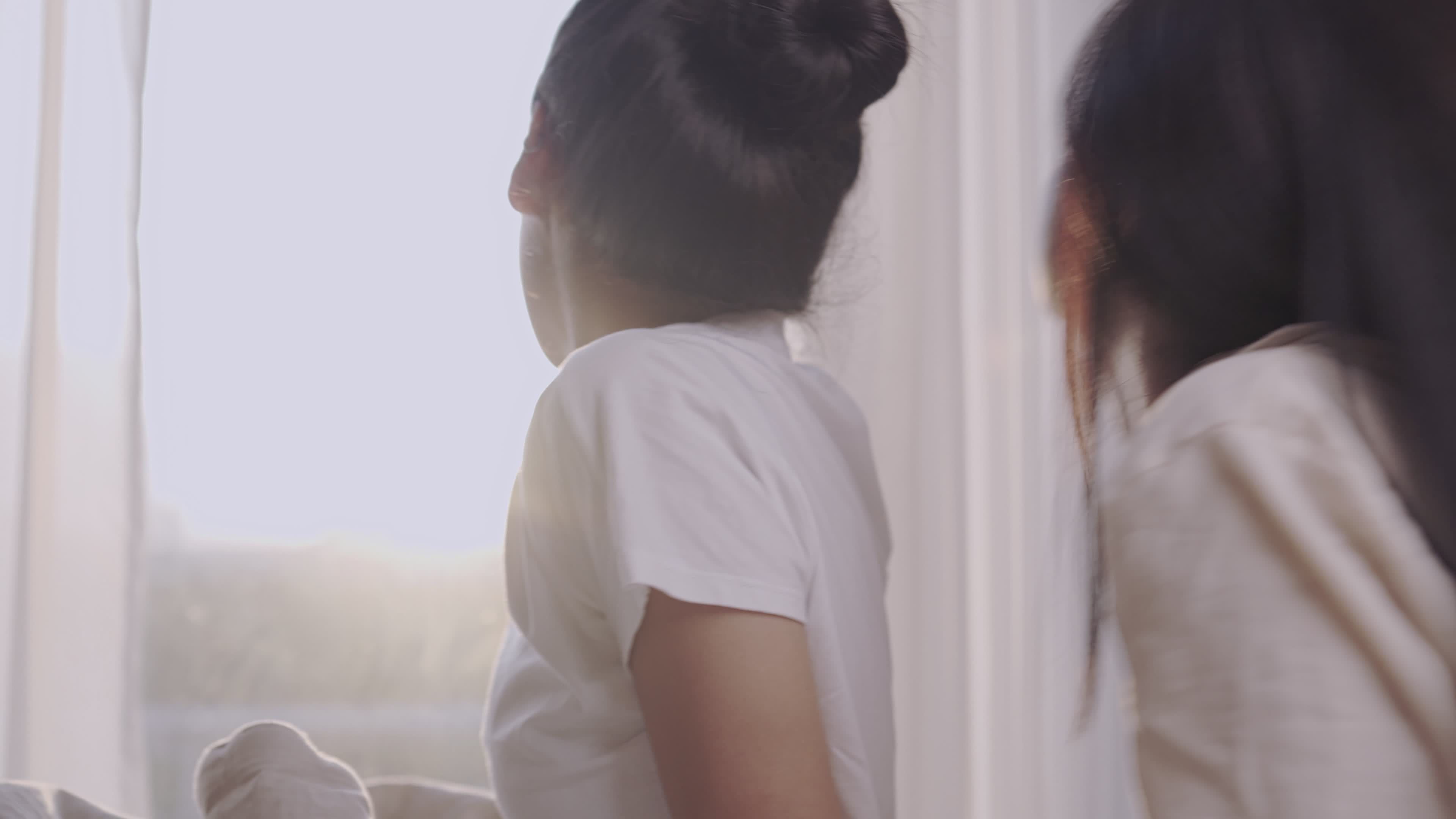 Asian lgbt lesbian couple wake up and enjoy morning sunlight view from high rise condo, lgbtq freedom lifestyle, same sex lover warmness relationship, quality sleep wellness, view from behind 7478447 Stock Video picture