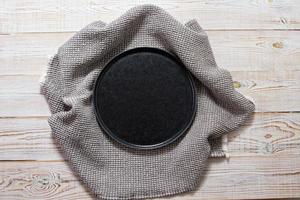 Tableware black empty plate on the table Top view photo