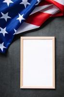 Empty frame for text and American flag on dark background. Concept of celebrating national holidays - Independence Day, Memorial Day or Labor Day. photo