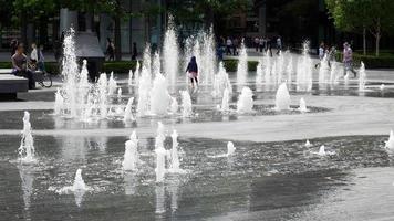 London, Uk, 2016. Person Standing in the Middle of a Fountain photo