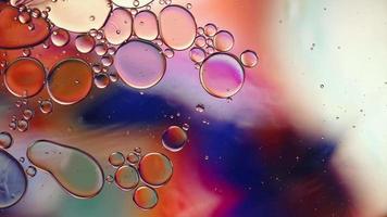 Abstract Colorful Food Oil Drops Bubbles and spheres Flowing on Water Surface, macro Videography video