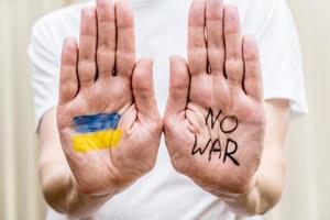 Ukrainian Flag and No War message painted on hands
