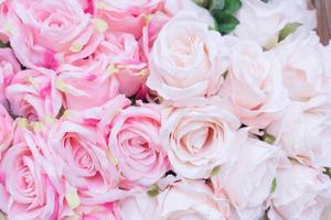 Close up of many fabric pale pink roses with blurred  background.