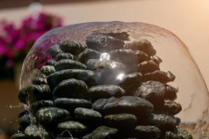 homemade fountain of black stones close-up photo