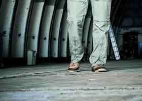 the legs of the person in the hangar photo