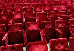 A lot of red seats in a movie theater. photo