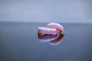 model of teeth for dentists to explain various tooth diseases or problems. grey background