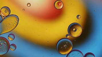 Abstract Colorful Food Oil Drops Bubbles and spheres Flowing on Water Surface, macro Videography video