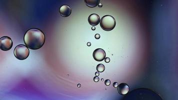 Abstract Colorful Food Oil Drops Bubbles and spheres Flowing on Water Surface, macro Videography video