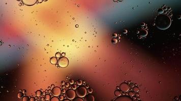 Abstract Colorful Food Oil Drops Bubbles and spheres Flowing on Water Surface, macro Videography video